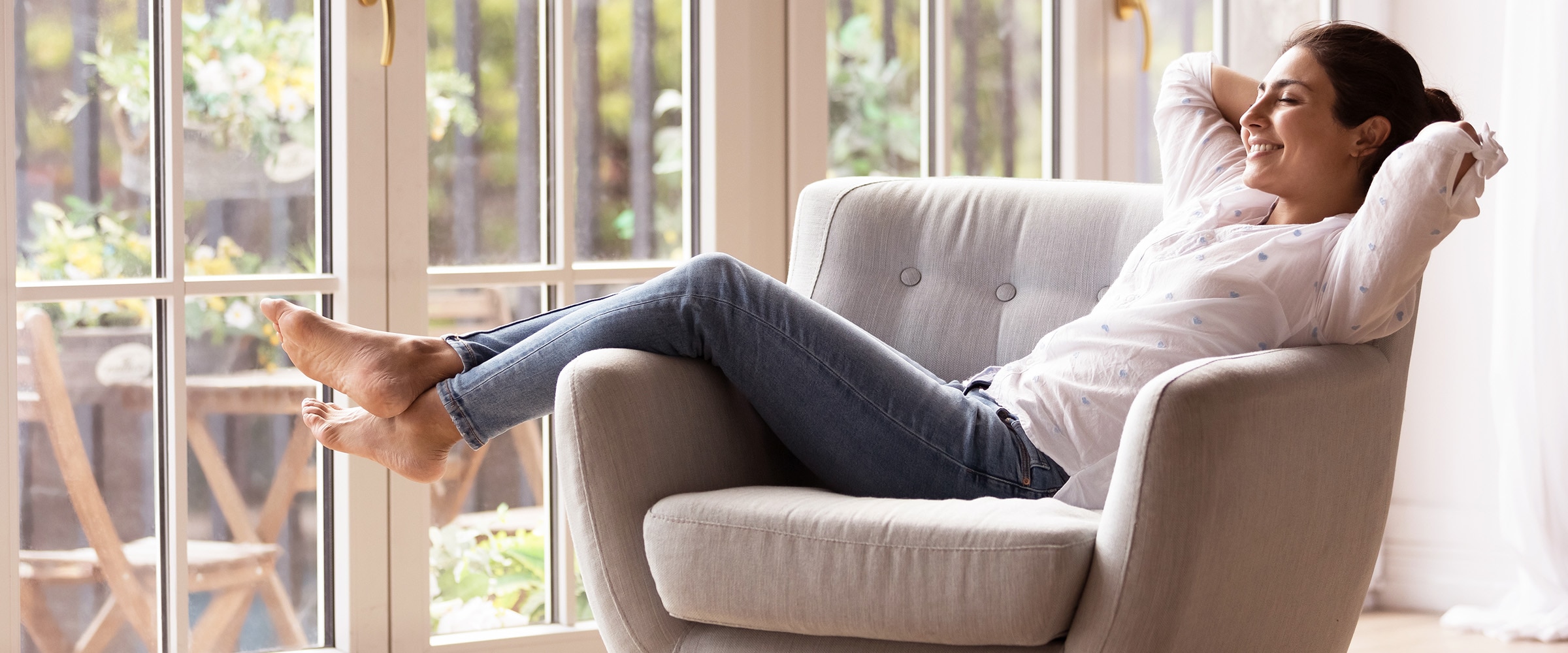 Photo of woman comfortably reclining in her chair.