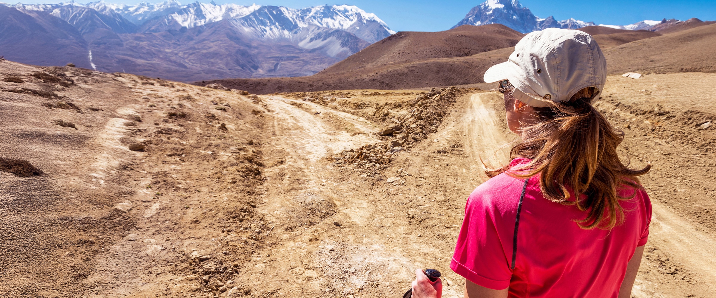 Image of woman looking at paths to take at rocky canyon.