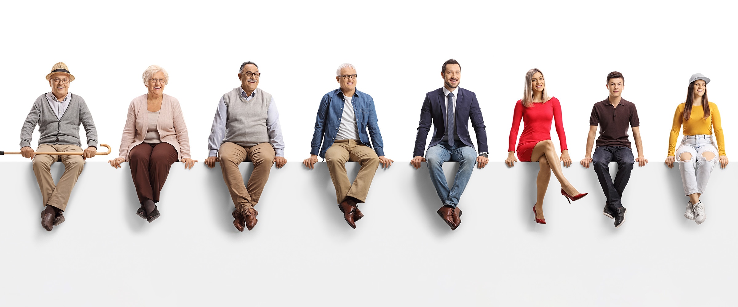 Photo of people of different ages sitting on a white bench.