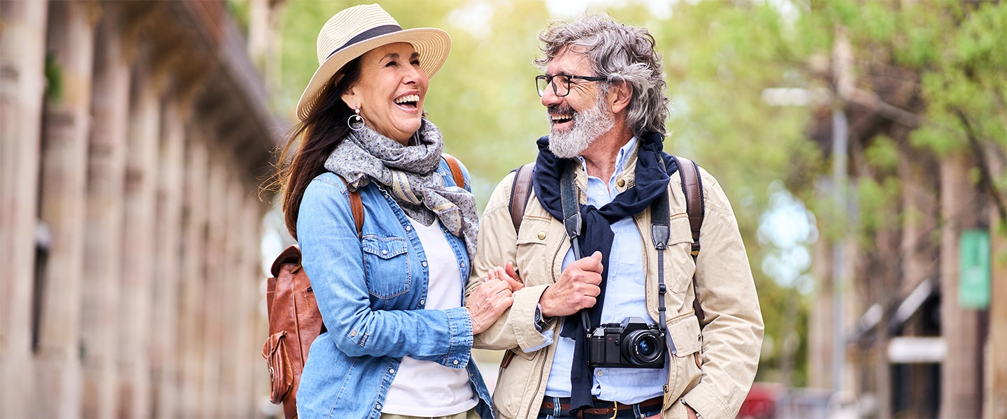 Photo of older couple walking and laughing together.