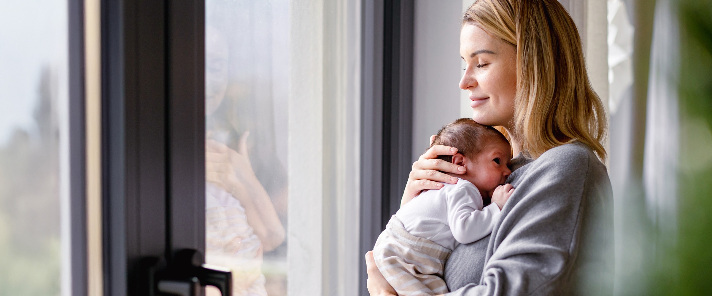 Photo of a mom holding her newborn.