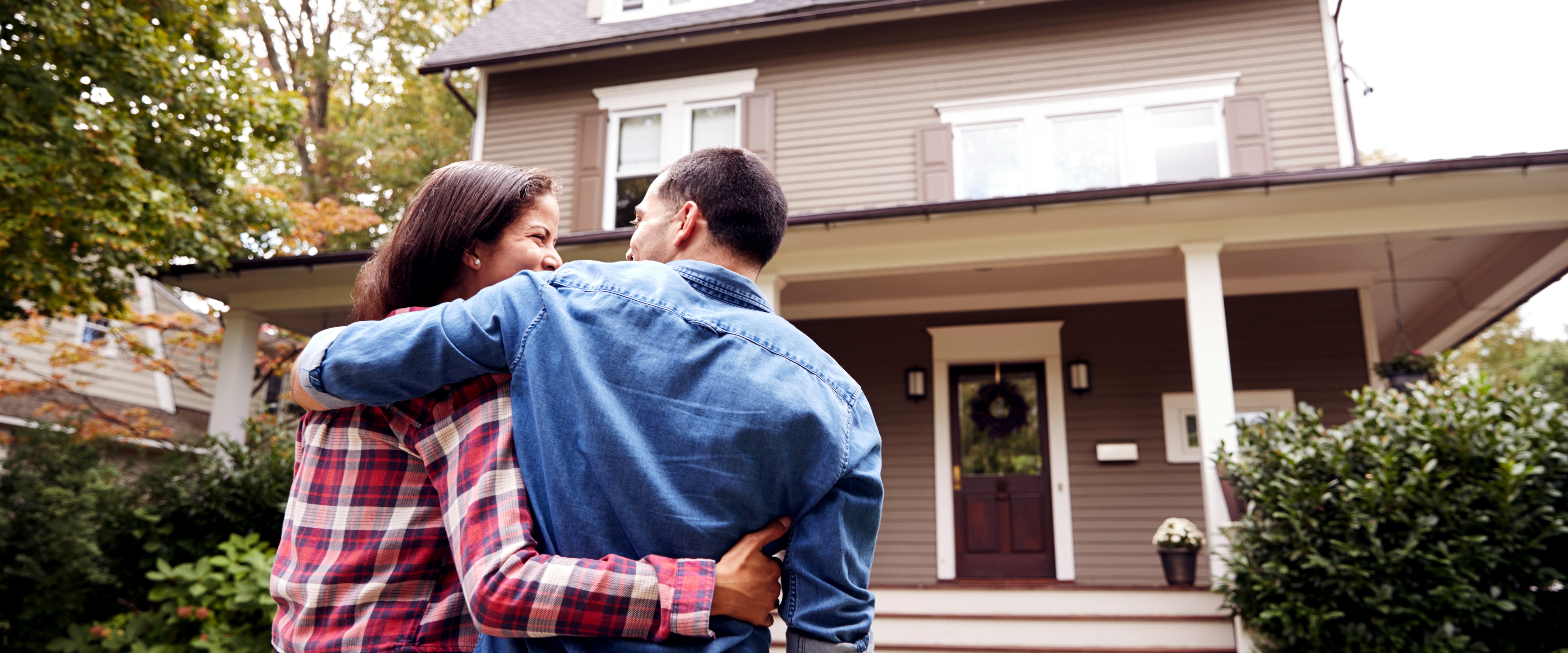 Photo of a couple walking up to a home.