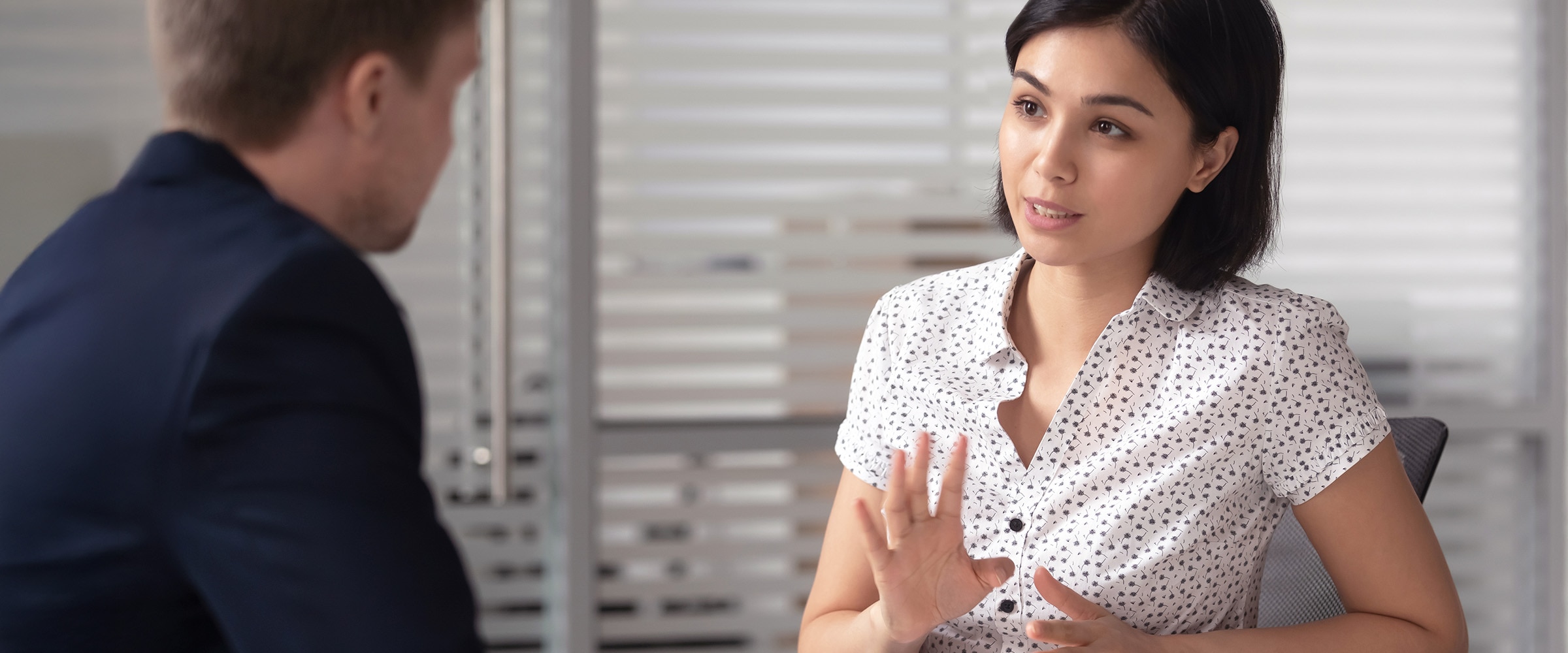 Photo of woman consulting with human resources employee.