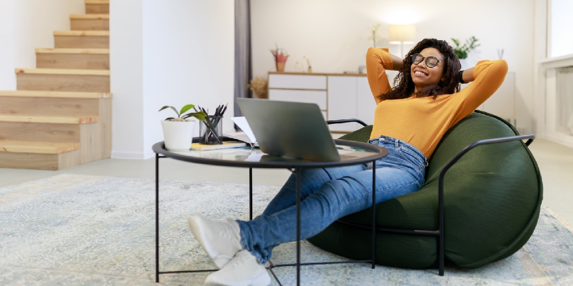 Photo of African-American woman leaning back comfortably in bean bag chair.