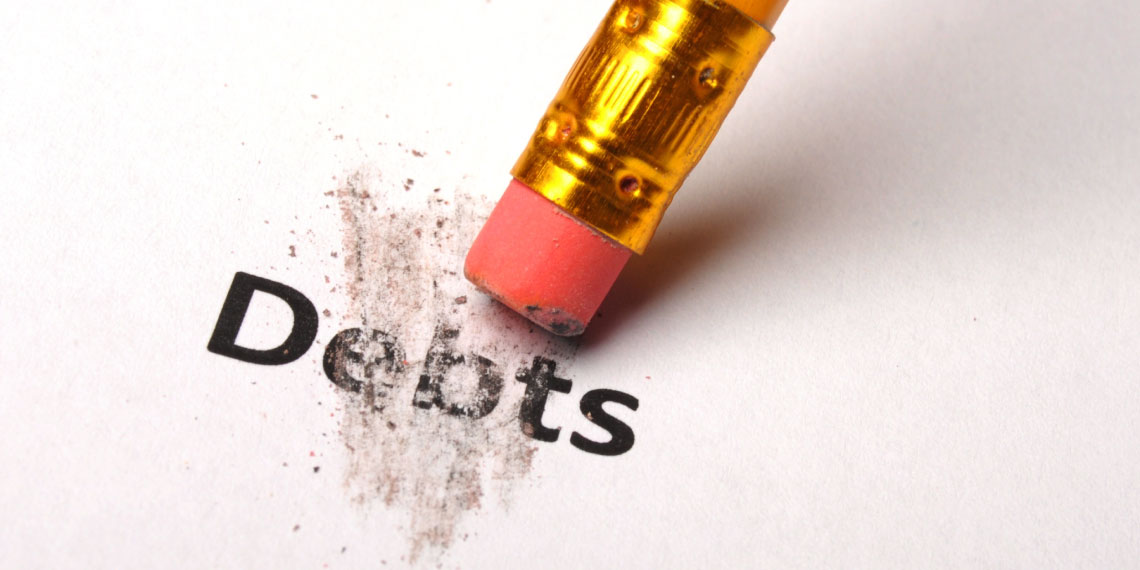 Photo of the eraser end of a pencil erasing the word debts.