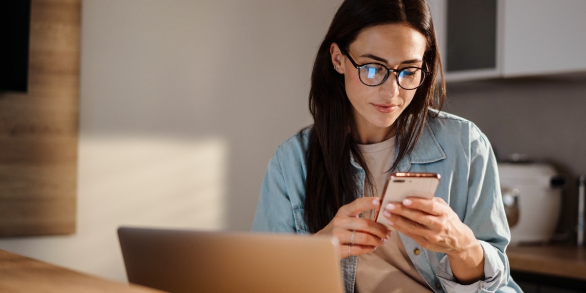 Photo of woman looking for answers on her smartphone.