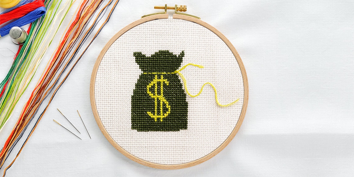 A needlepoint of a money bag