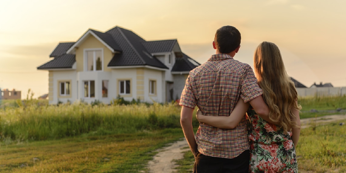 Photo of young couple looking at a home they want to purchase.