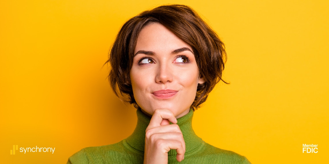 Photo of woman with finger to her lips while thinking.