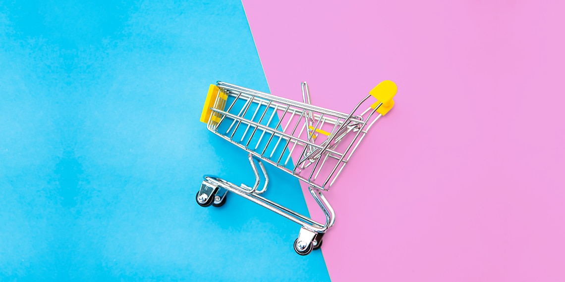 A shopping cart on a half-blue half pink background.